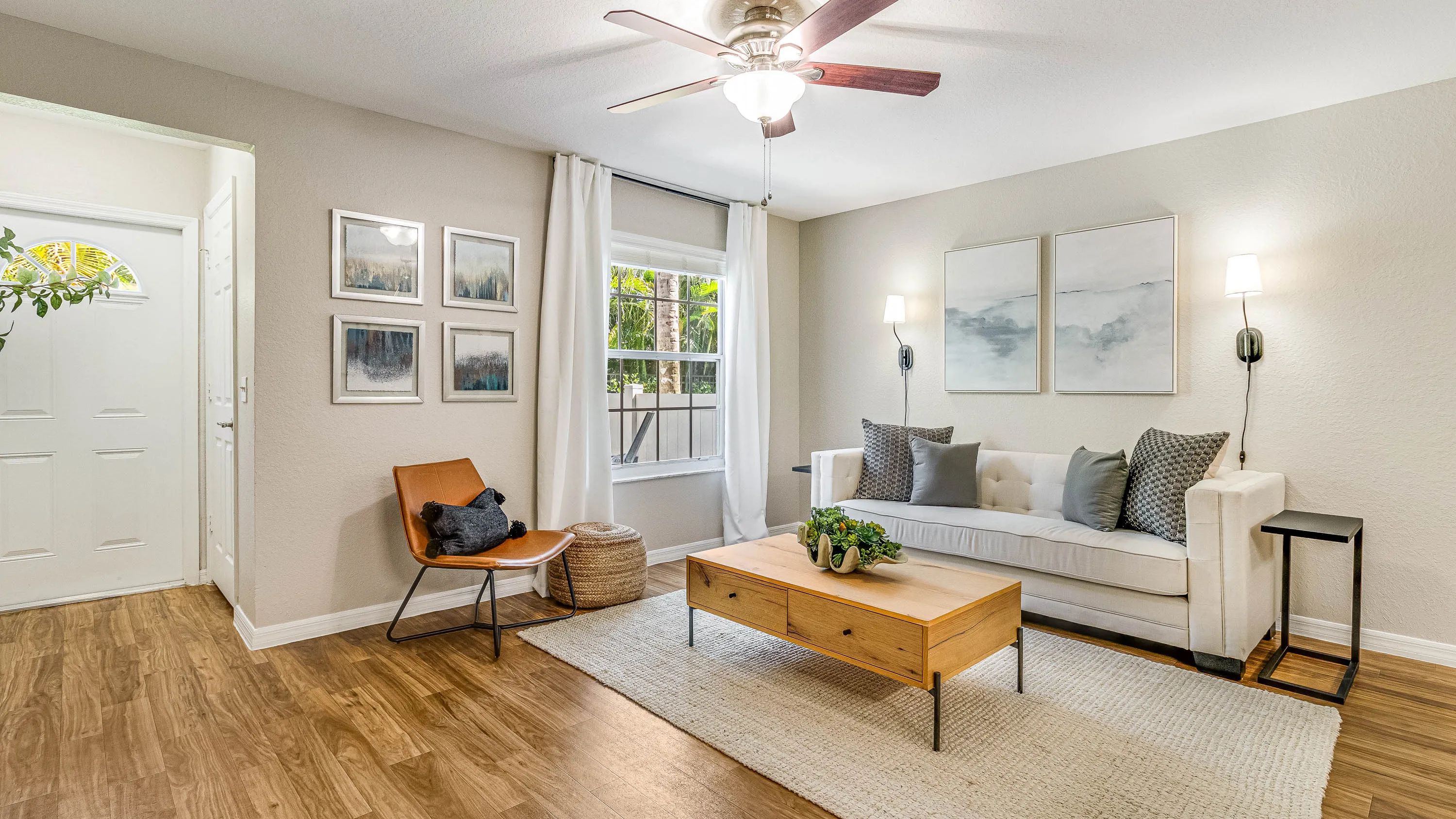 All living rooms epitomize breezy comforts with ceiling fans and large picture windows. 