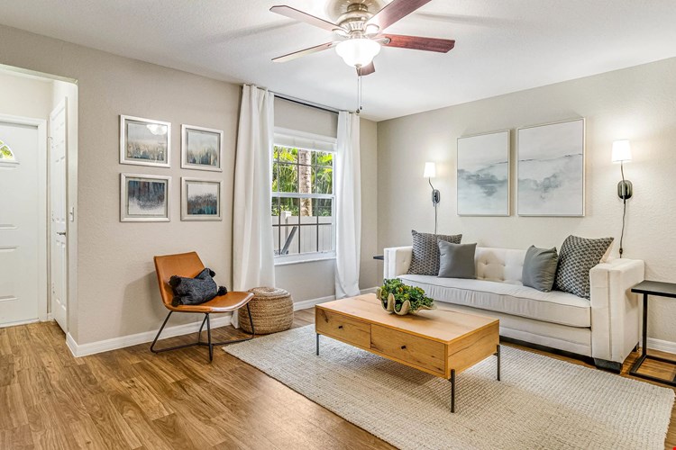 All living rooms epitomize breezy comforts with ceiling fans and large picture windows.