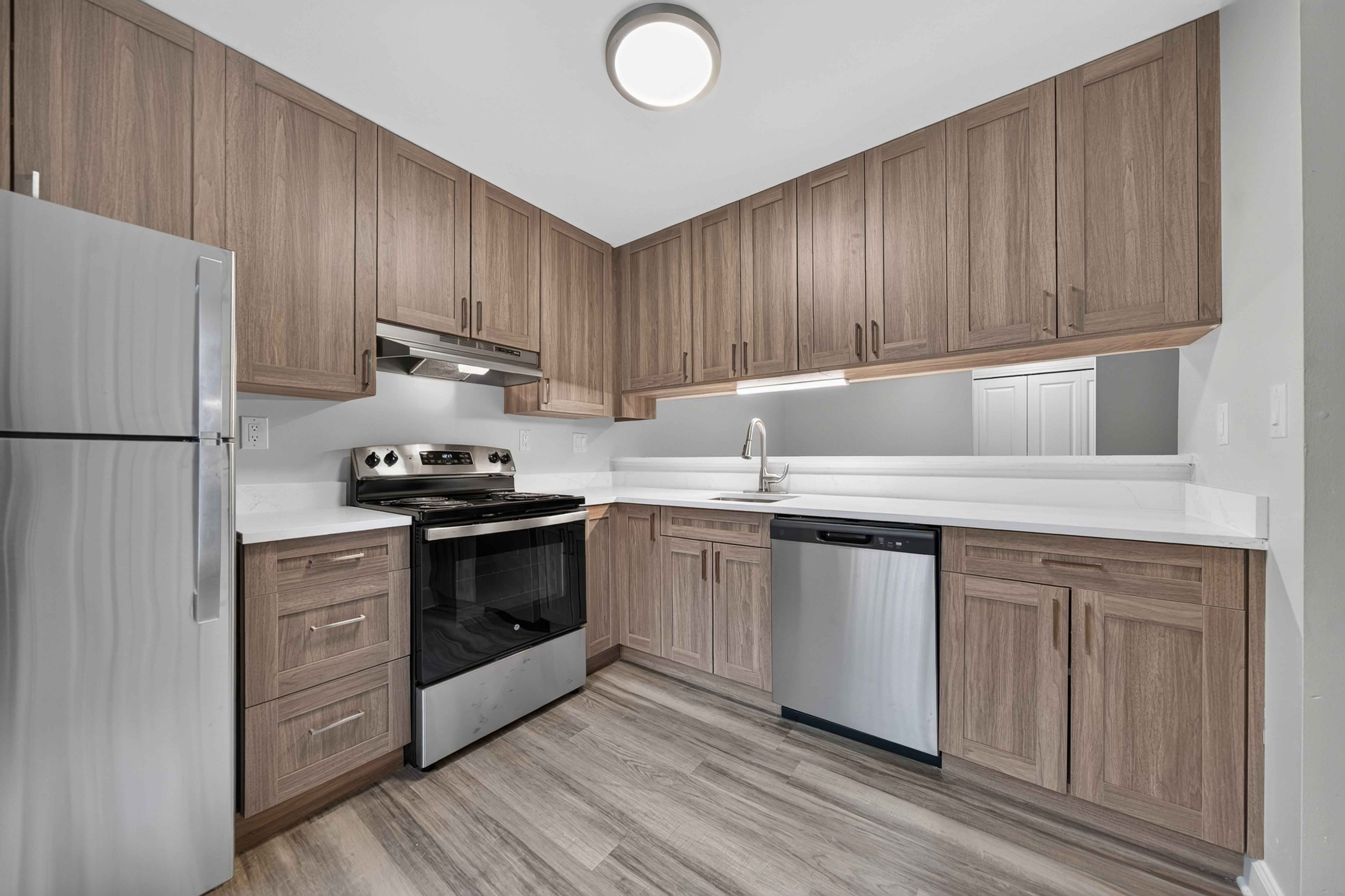 Stainless steel appliances and soft-close cabinets at Park Lane Apartments in Southfield, MI.