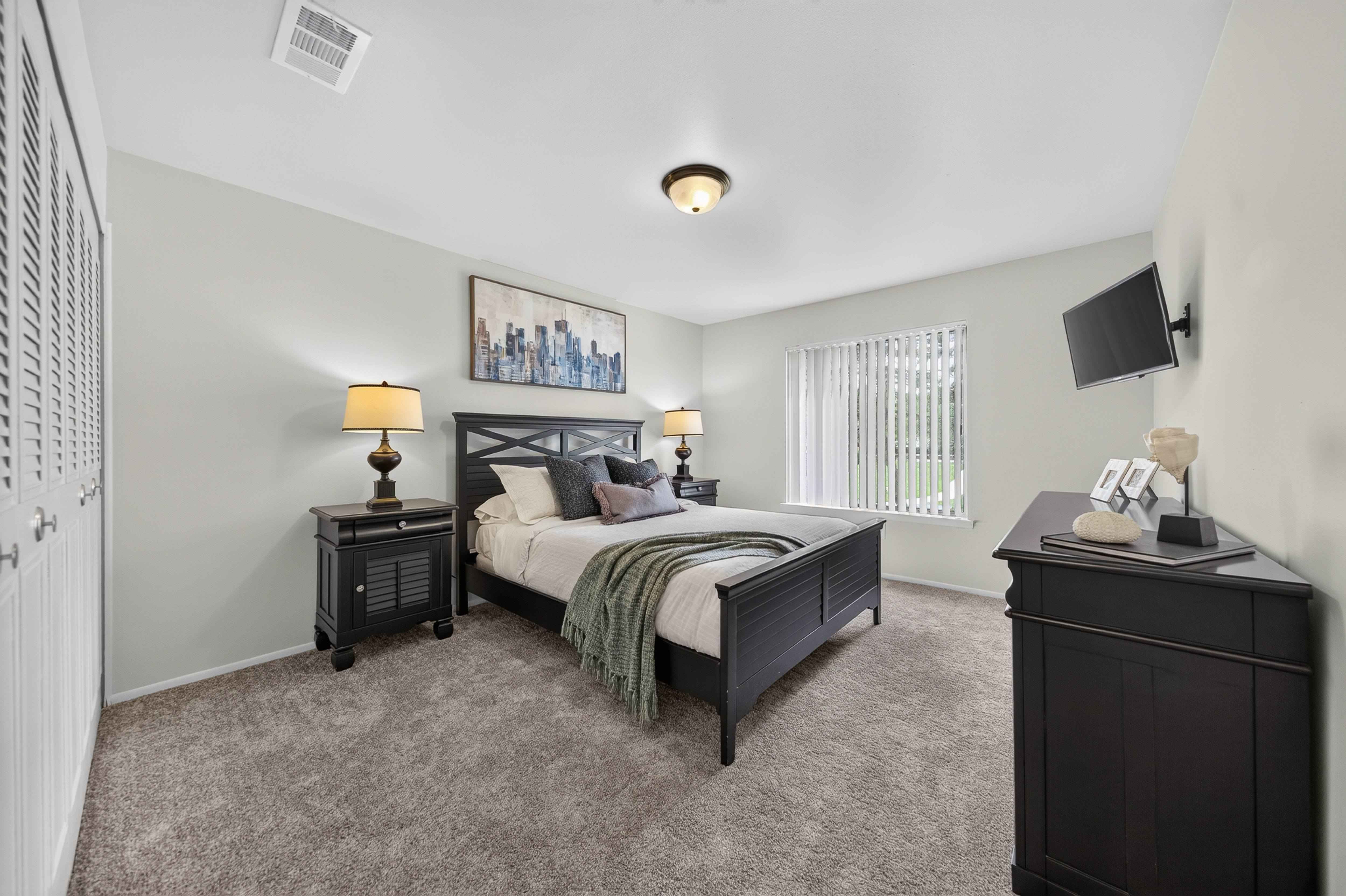 Cozy bedroom with ample storage space at Drawbridge Apartments in Harrison Township, MI.