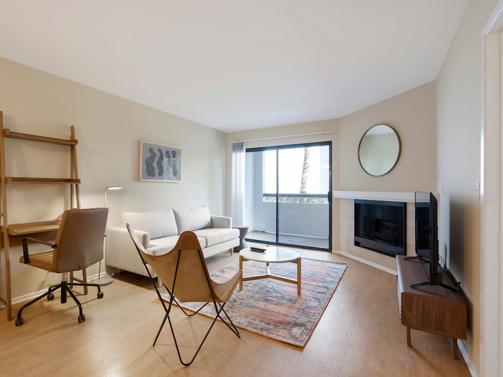 Furnished+ apartment homes come outfitted with a sofa, side chair, side table, coffee table, TV stand and 50" Television (Representative Image – exact items and style of furnishings may vary)