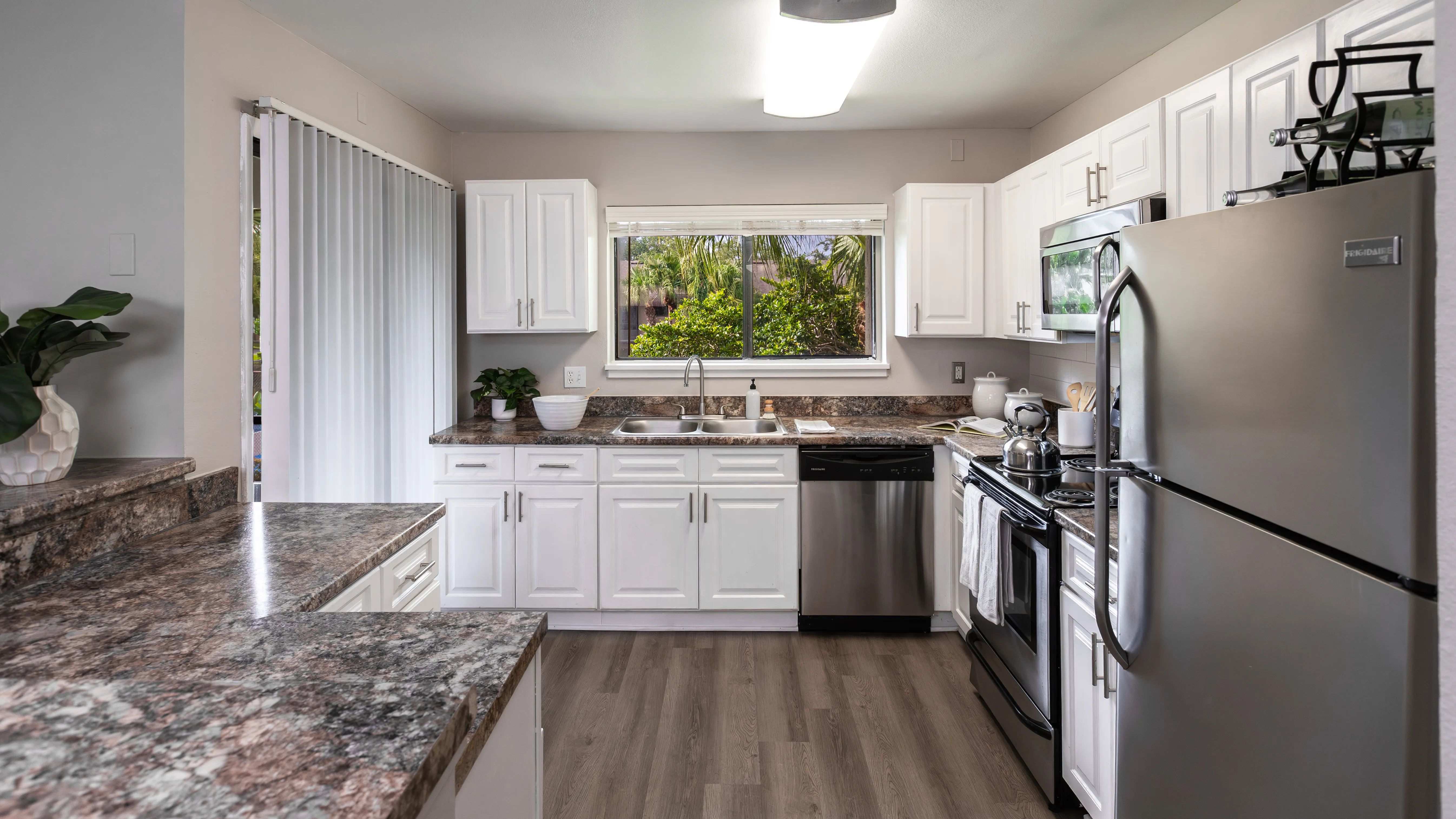 Cook in comfort with a bright window view, generous counter space, and stainless steel appliances.