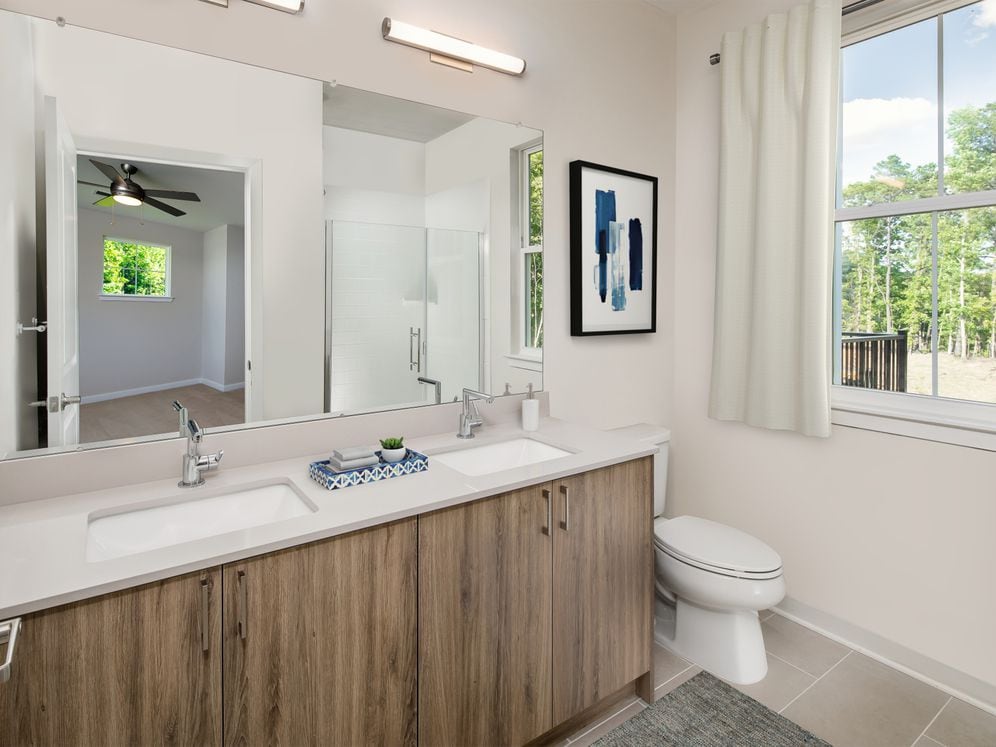 Upgrade Scheme townhome bath with oak cabinetry, grey quartz countertop, and tile flooring