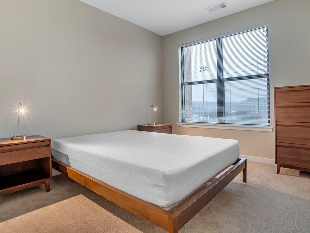Furnished+ apartment homes feature queen bed with mattress, dresser, nightstands, and lamps (Representative Image – exact items and style of furnishings may vary)