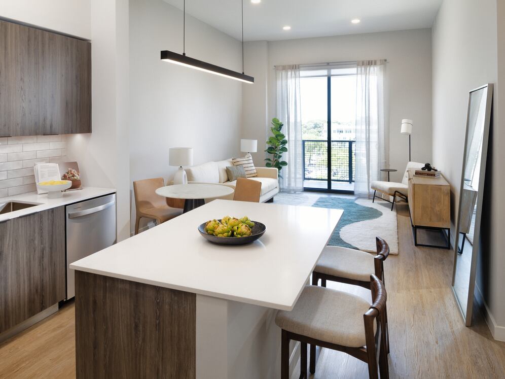 Upgrade Collection II kitchen with espresso cabinetry, white tile backsplash, stainless steel appliances, and hard-surface vinyl plank flooring