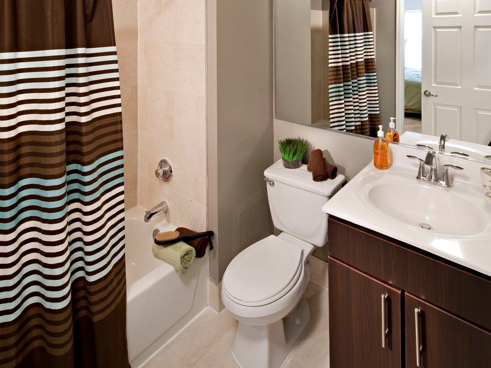 Classic Package I bath with espresso cabinetry, beige laminate countertop, and hard surface plank or vinyl tile flooring