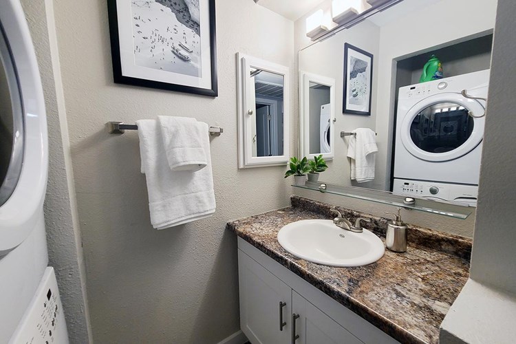 Newly renovated bathrooms featuring a large mirror and a medicine cabinet.