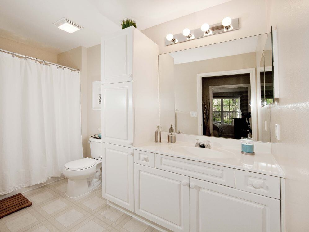 Classic Scheme bath with white shaker cabinetry, white laminate countertops, and hard surface flooring
