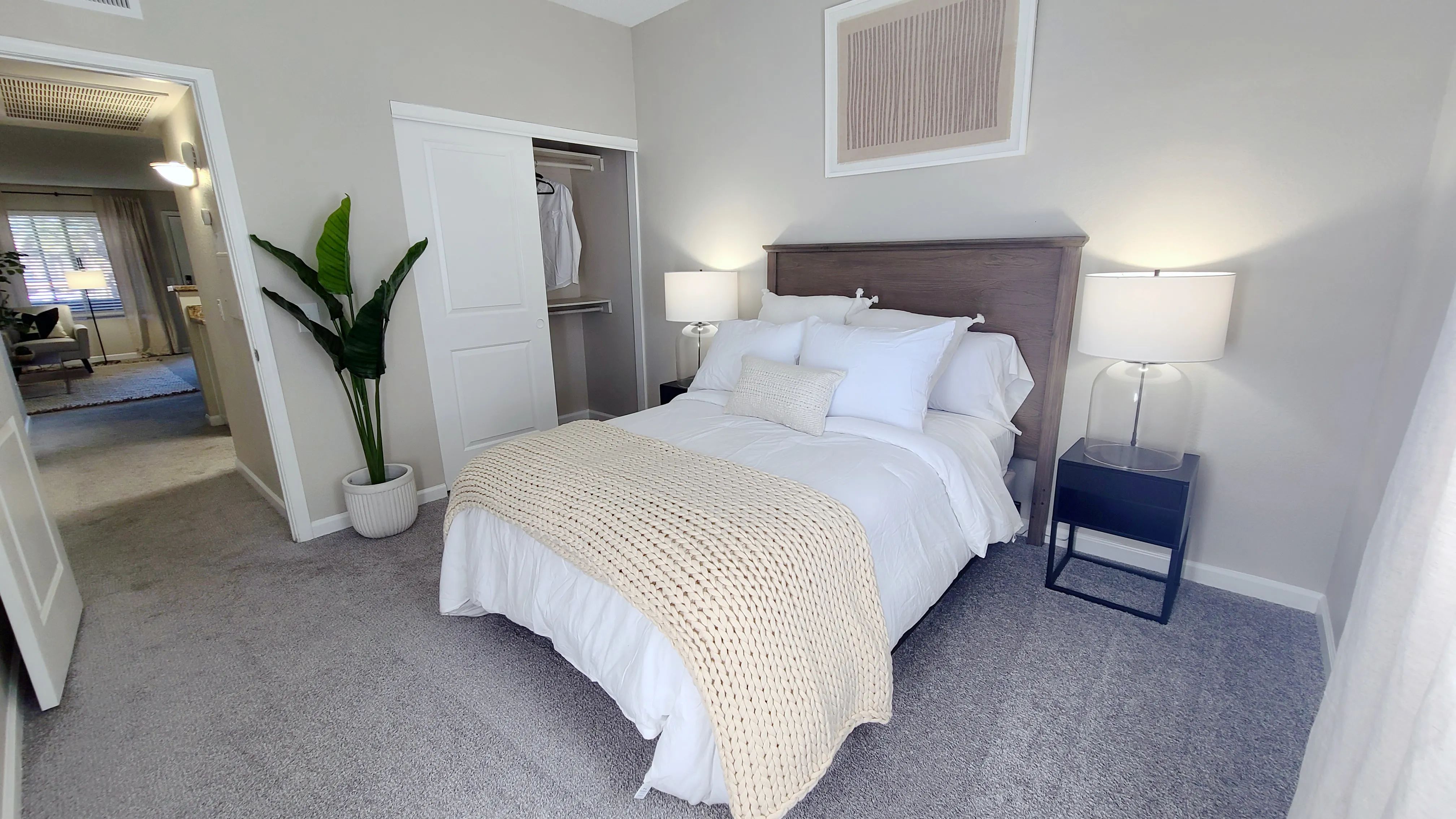 Our guest bedrooms feature plush carpeting and spacious closets with dual shelving, offering functionality and convenience. 