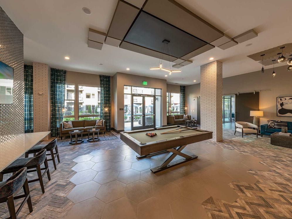 East building resident lounge with billiards, flat screen television, and lounge seating