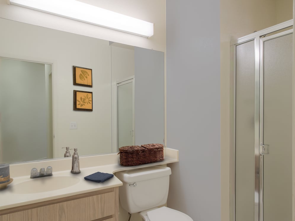 Classic Package I bath with light oak cabinetry, white laminate countertops, and hard surface flooring