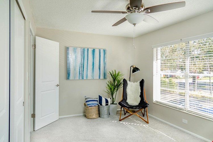Your primary bedroom features a spacious walk-in closet with built-in organizers and a ceiling fan.