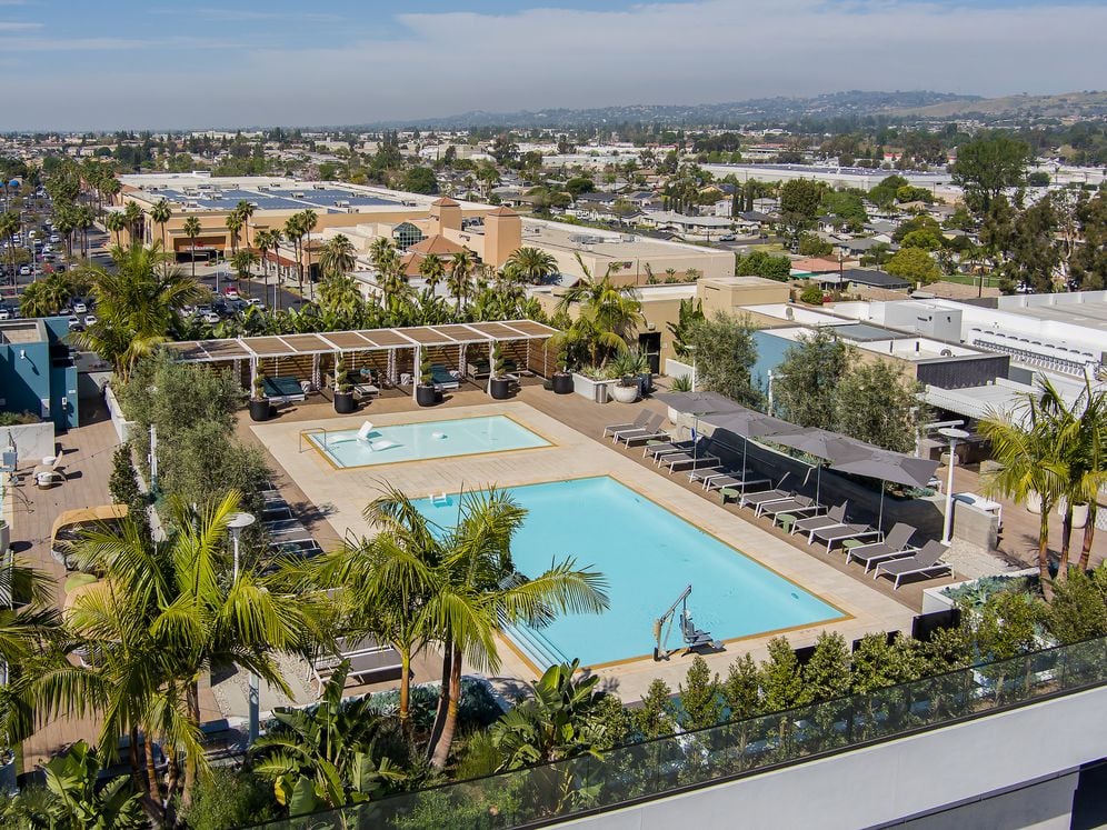 Building A rooftop pool and sundeck with lounge seating and cabanas