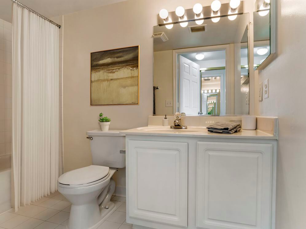 Classic Package I bath with white cabinetry, beige laminate countertops, and tile flooring