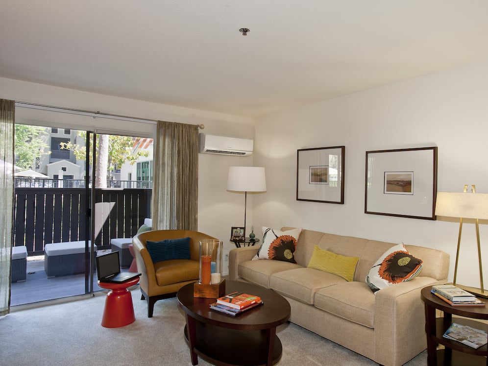 Classic Package living area with carpeted flooring and patio access