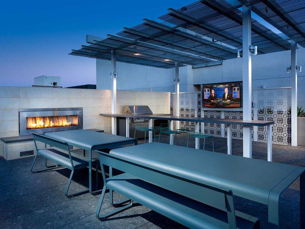 Roofdeck with outdoor fireplace, barbeque grills, flatscreen television and seating