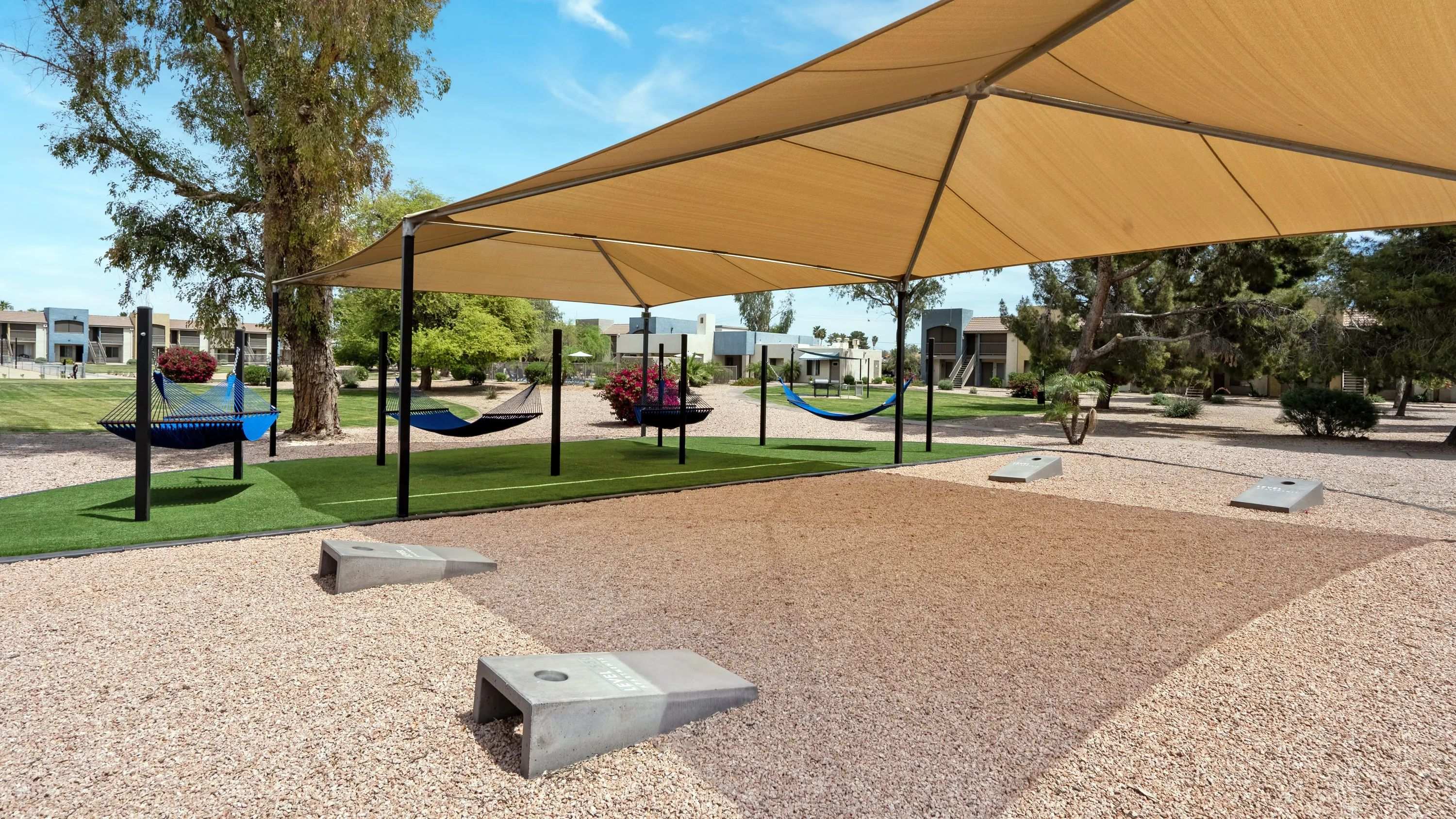 Gather neighbors and friends for an exciting game of cornhole by the hammock garden, infusing vibrancy and playfulness into your day. Fun for everyone! 