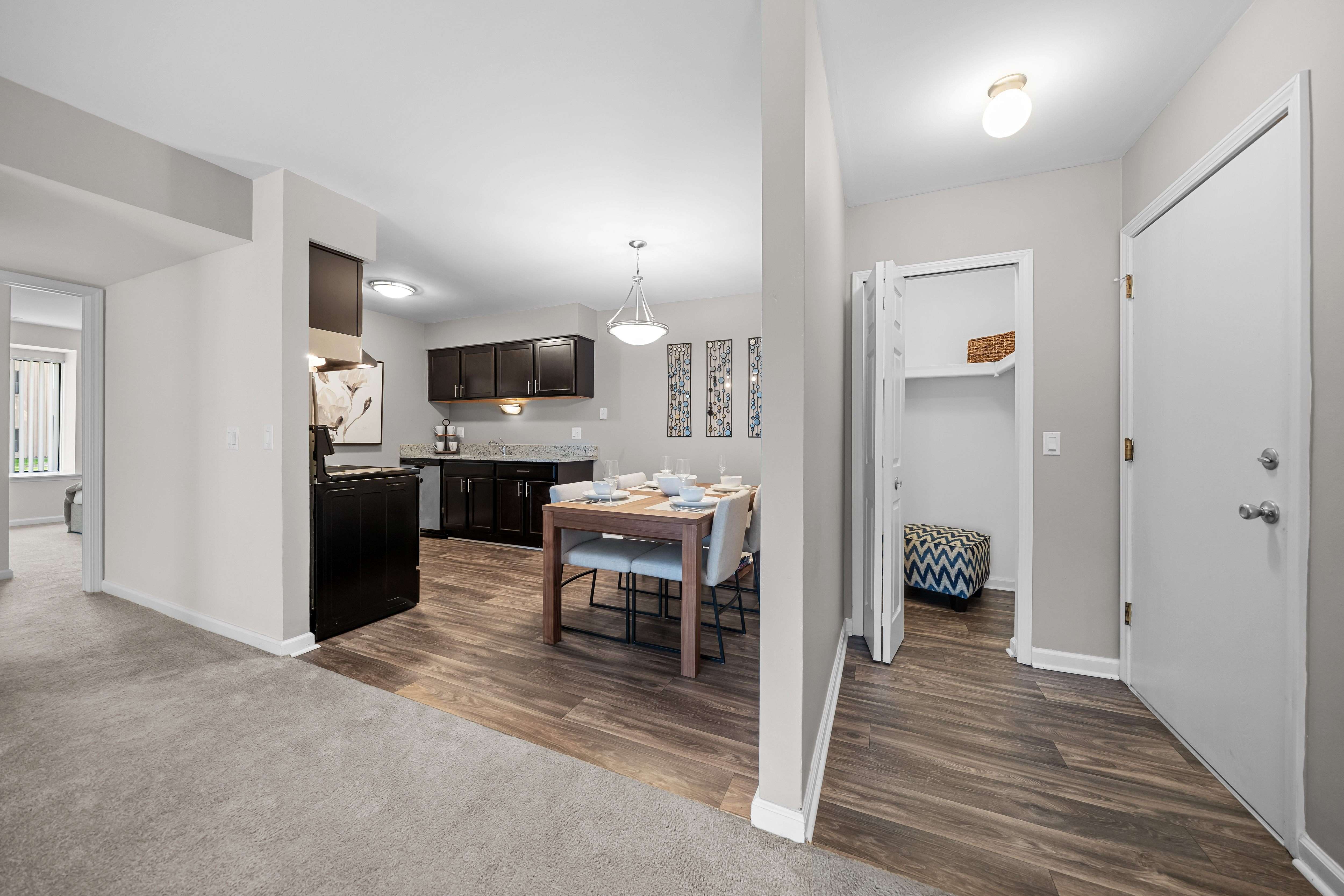 Open concept Living-Dining Area with natural lighting at Lakeside Village Apartments Clinton Township, MI