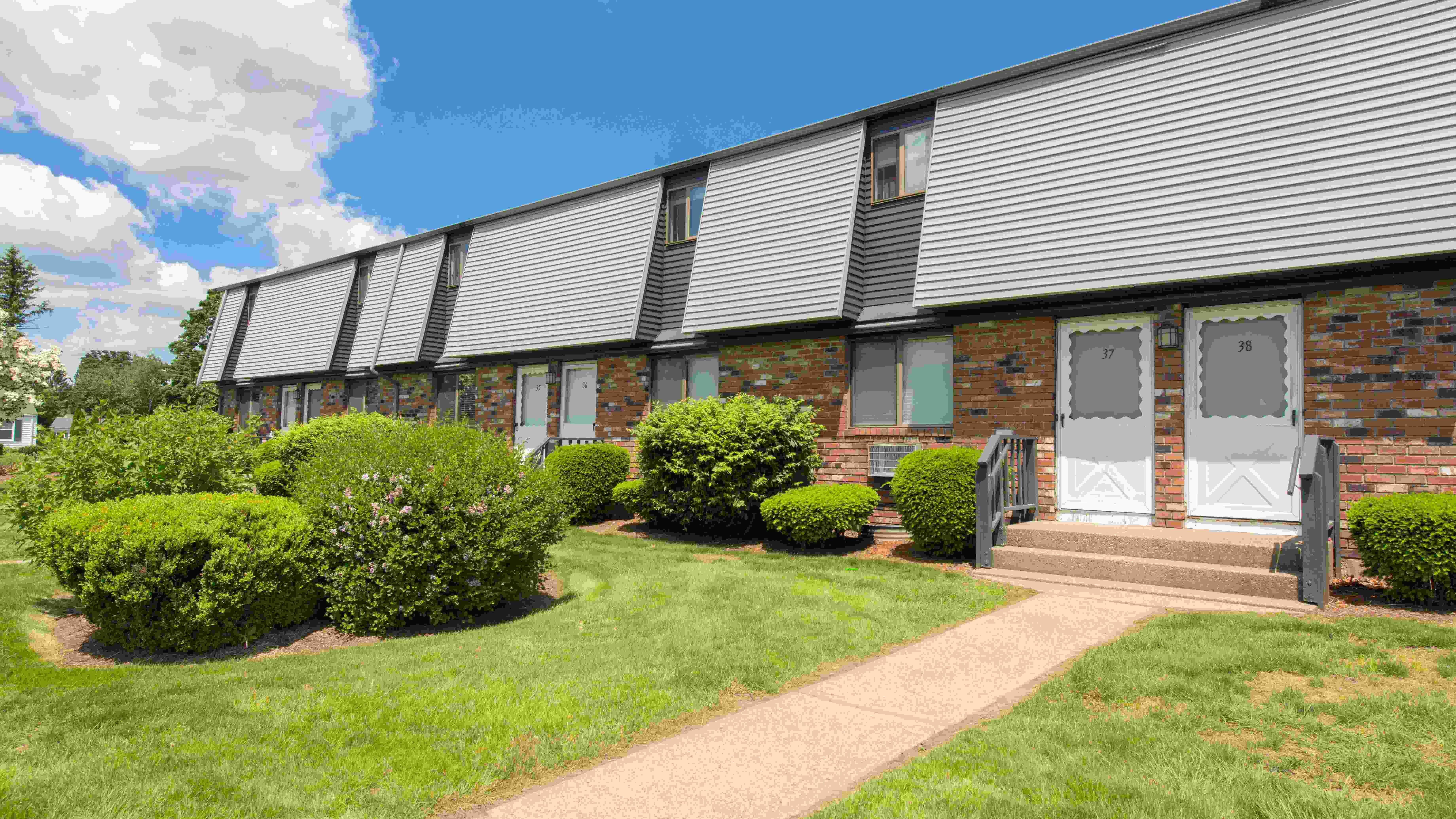 Experience the allure of classic red brick charm and lush green surroundings in our well-cared-for community.