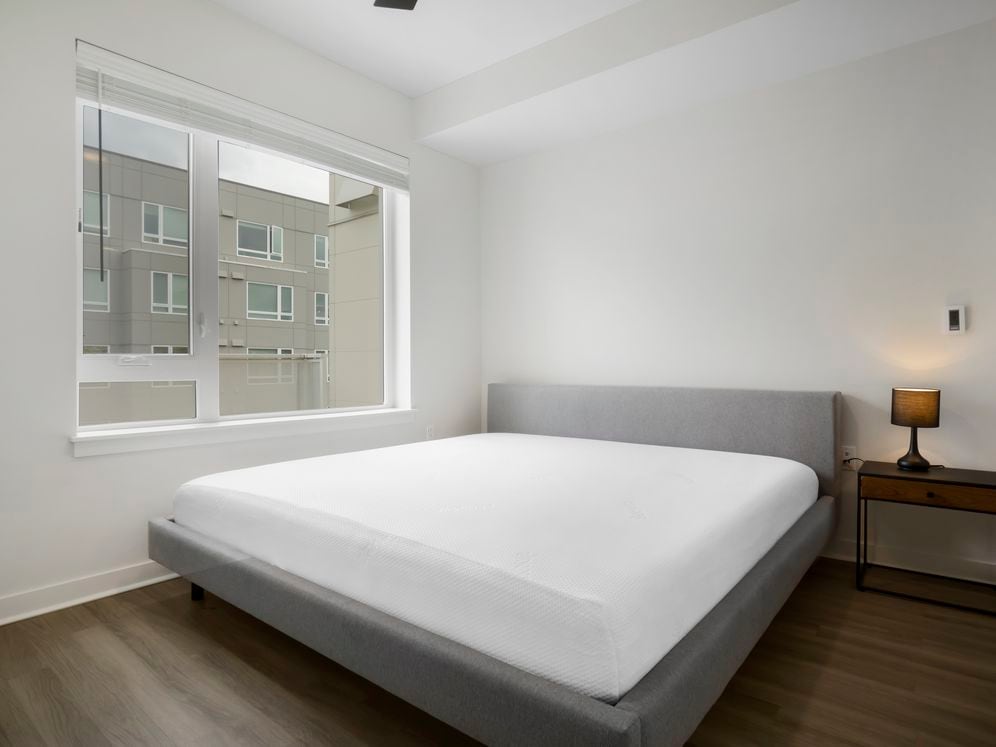 Furnished+ apartment homes feature queen bed with mattress, dresser, nightstands, and lamps (Representative Image – exact items and style of furnishings may vary)