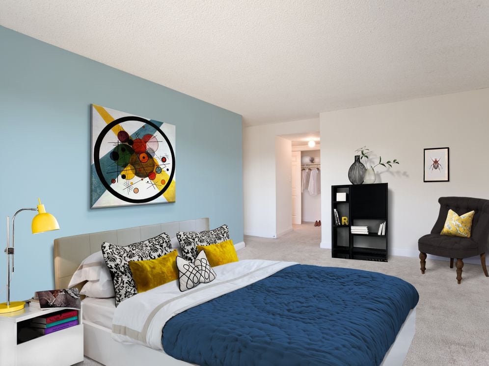 Bedroom with accent wall and carpeted flooring