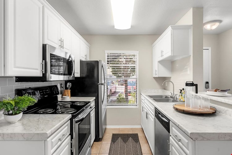 Our beautifully remodeled, chef-inspired kitchens adorned with opulent marble-like countertops and stainless-steel appliances.