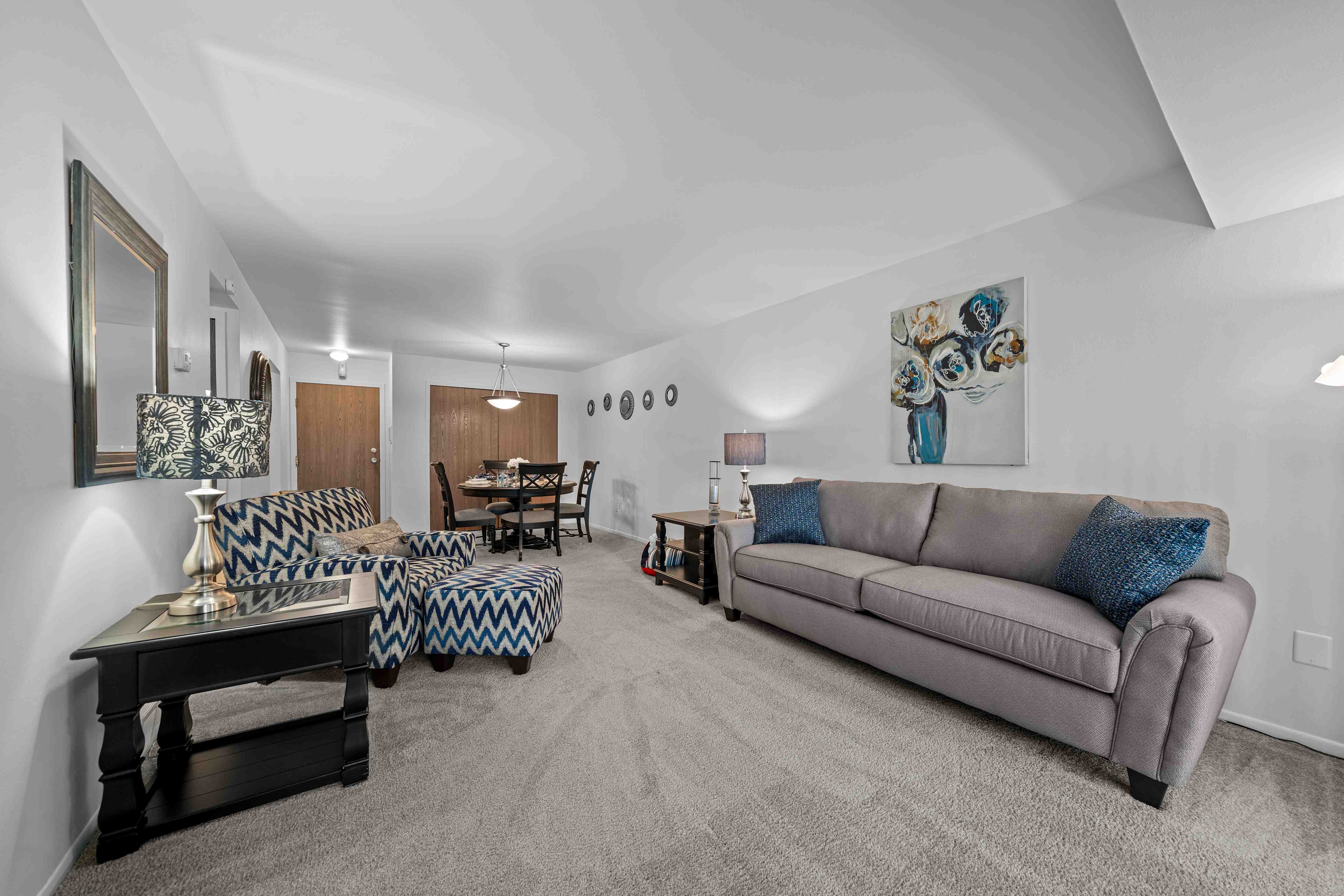 Spacious living room with natural light at Westwood Village Apartments in Westland, MI