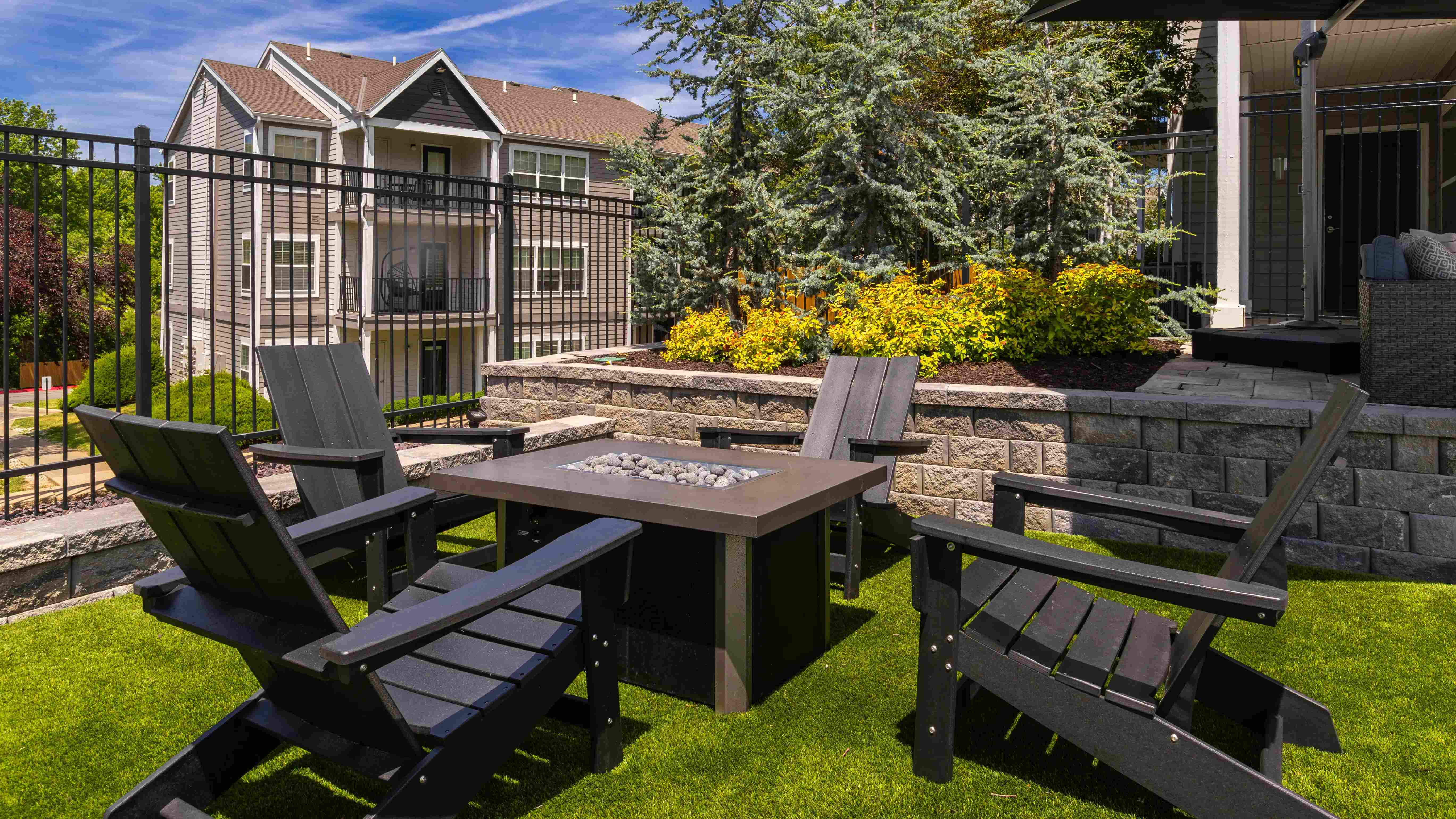 Relax and unwind in our cozy outdoor fire pit area, complete with comfortable Adirondack chairs and lush greenery. Perfect for socializing or enjoying a quiet evening under the stars.