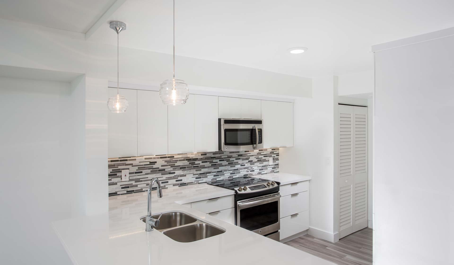 Modern kitchen with stainless steel appliances, granite countertops and designer cabinets