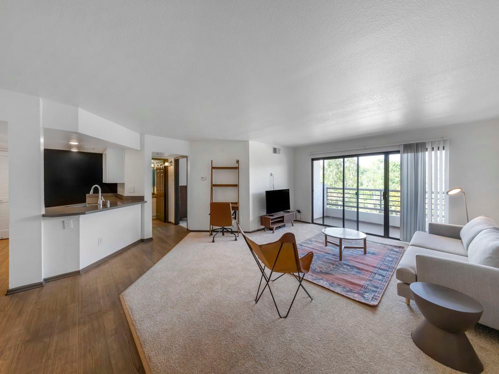 Furnished+ apartment homes come outfitted with a sofa, side chair, side table, coffee table, TV stand and 50" Television (Representative Image – exact items and style of furnishings may vary)