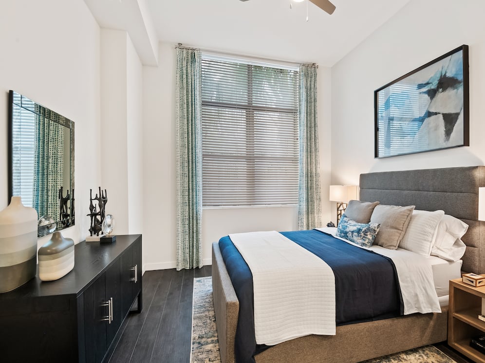 Bedroom with ceiling fan and hard-surface vinyl plank flooring