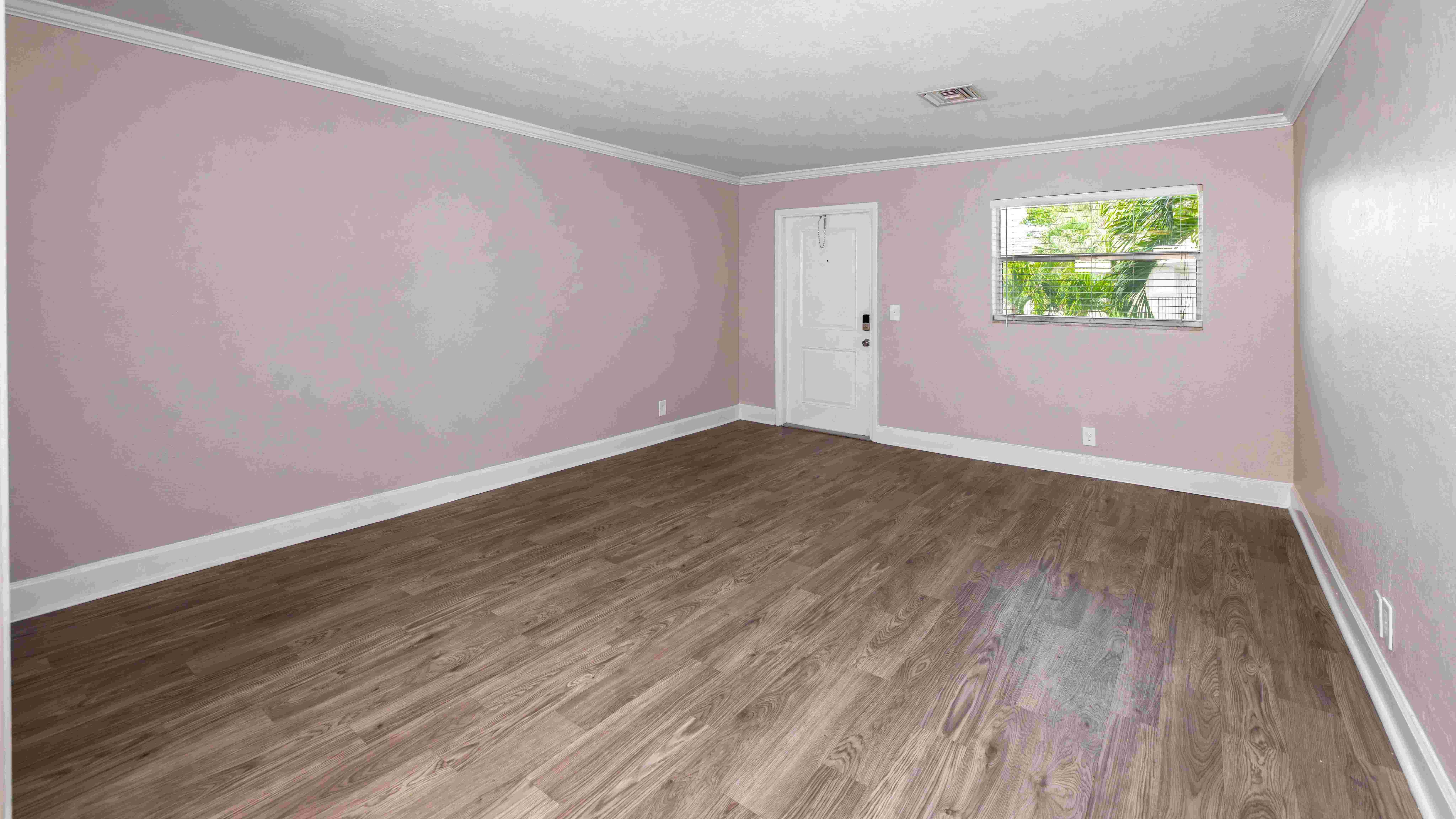 Bask in comfort within a spacious living room with sleek floors and ample natural lighting, creating an inviting and refreshing retreat where you can feel relaxed. 