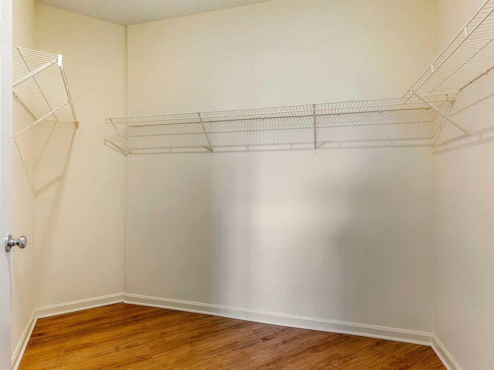 Walk-in closet with linen racks and storage space