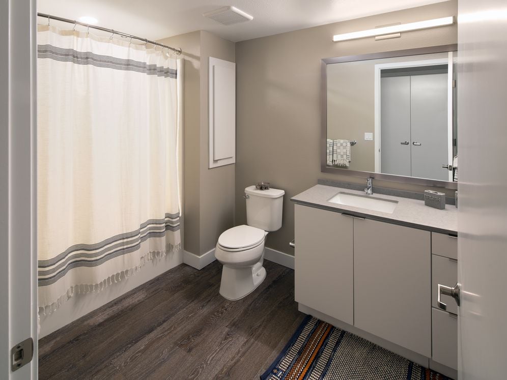 Bath with quartz countertop and hard surface flooring
