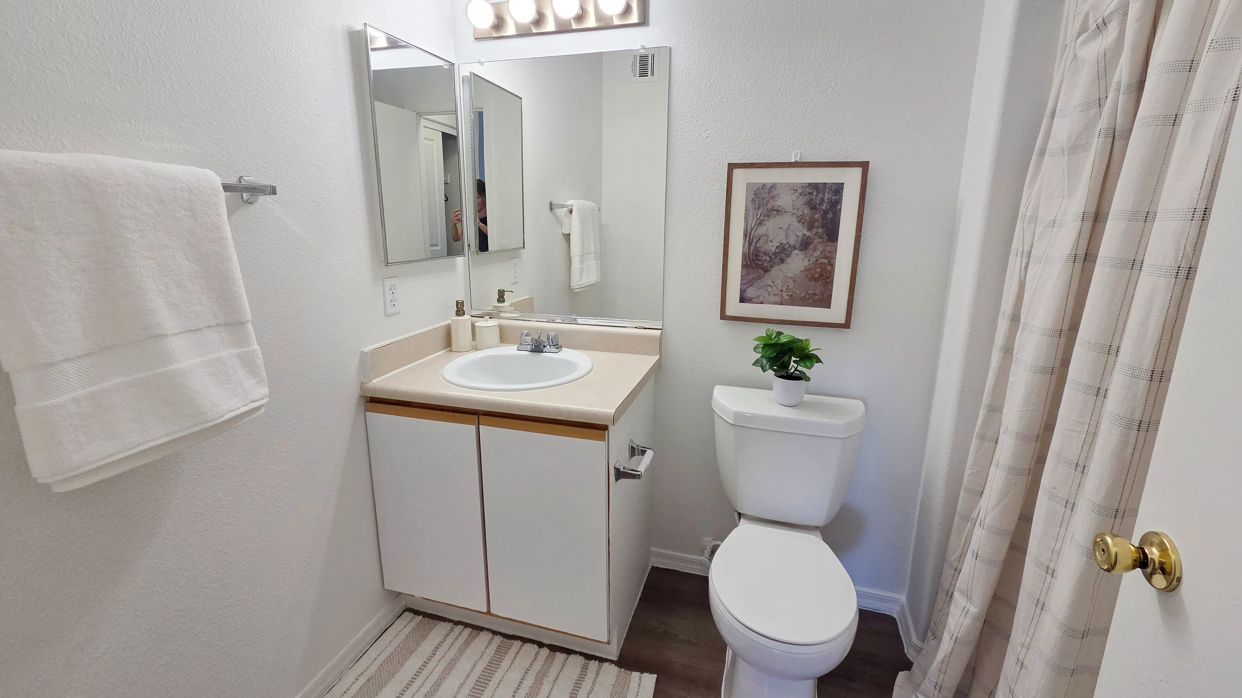 Featuring a spacious vanity, ample mirror space, and a full tub-shower combination, this thoughtfully designed space offers both comfort and convenience.