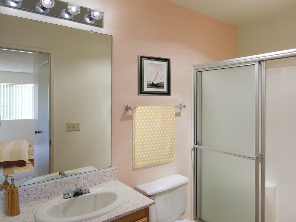 Classic Package bath with oak cabinetry, beige speckled laminate countertops, and tile flooring