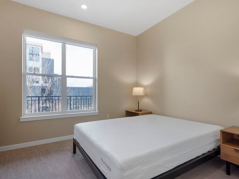 Furnished+ apartment homes feature queen bed with mattress, dresser, nightstands, and lamps (Representative Image – exact items and style of furnishings may vary)