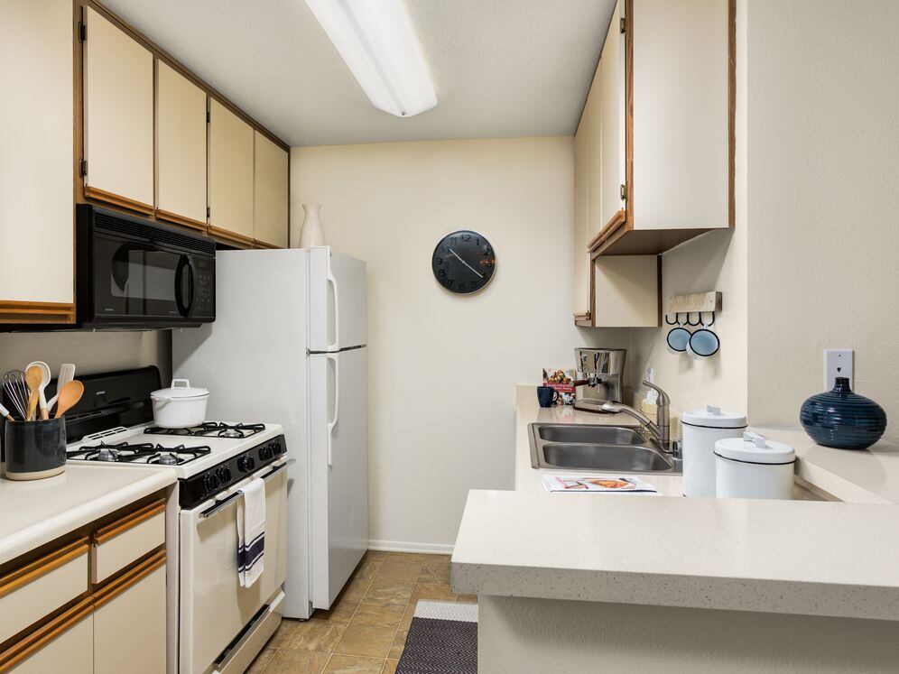 Classic I kitchen with white-on-white appliances and breakfast bars