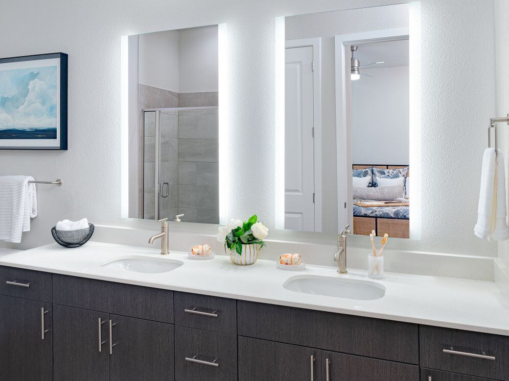 Bath with quartz countertop, tile backsplash, and hard surface flooring