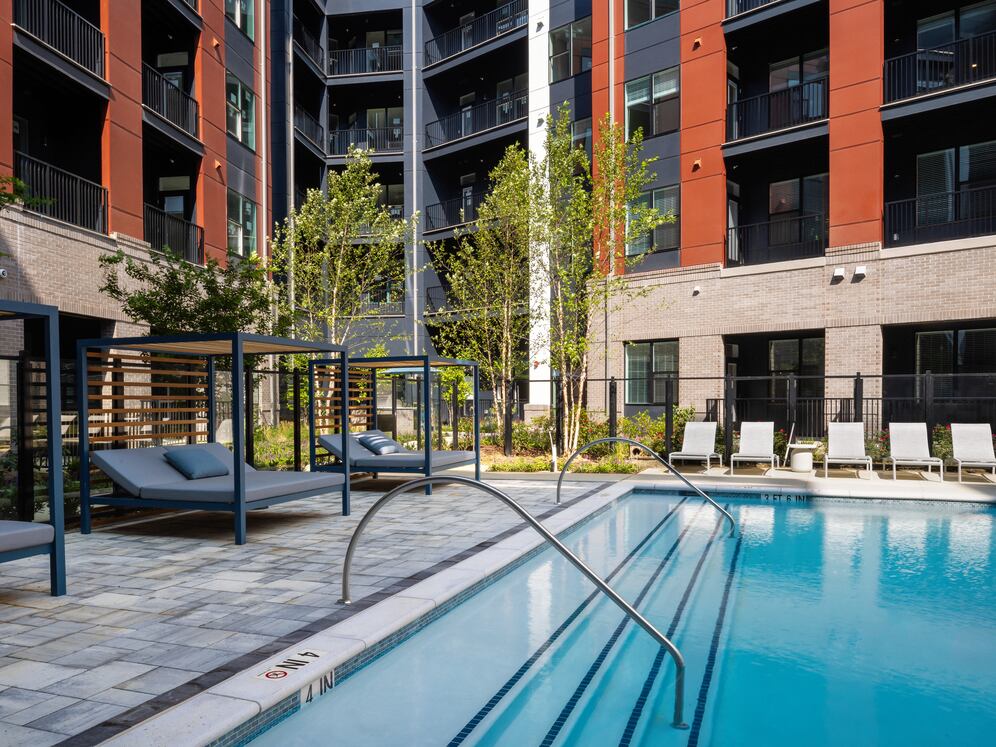 Resort-style pool and sundeck with cabanas 