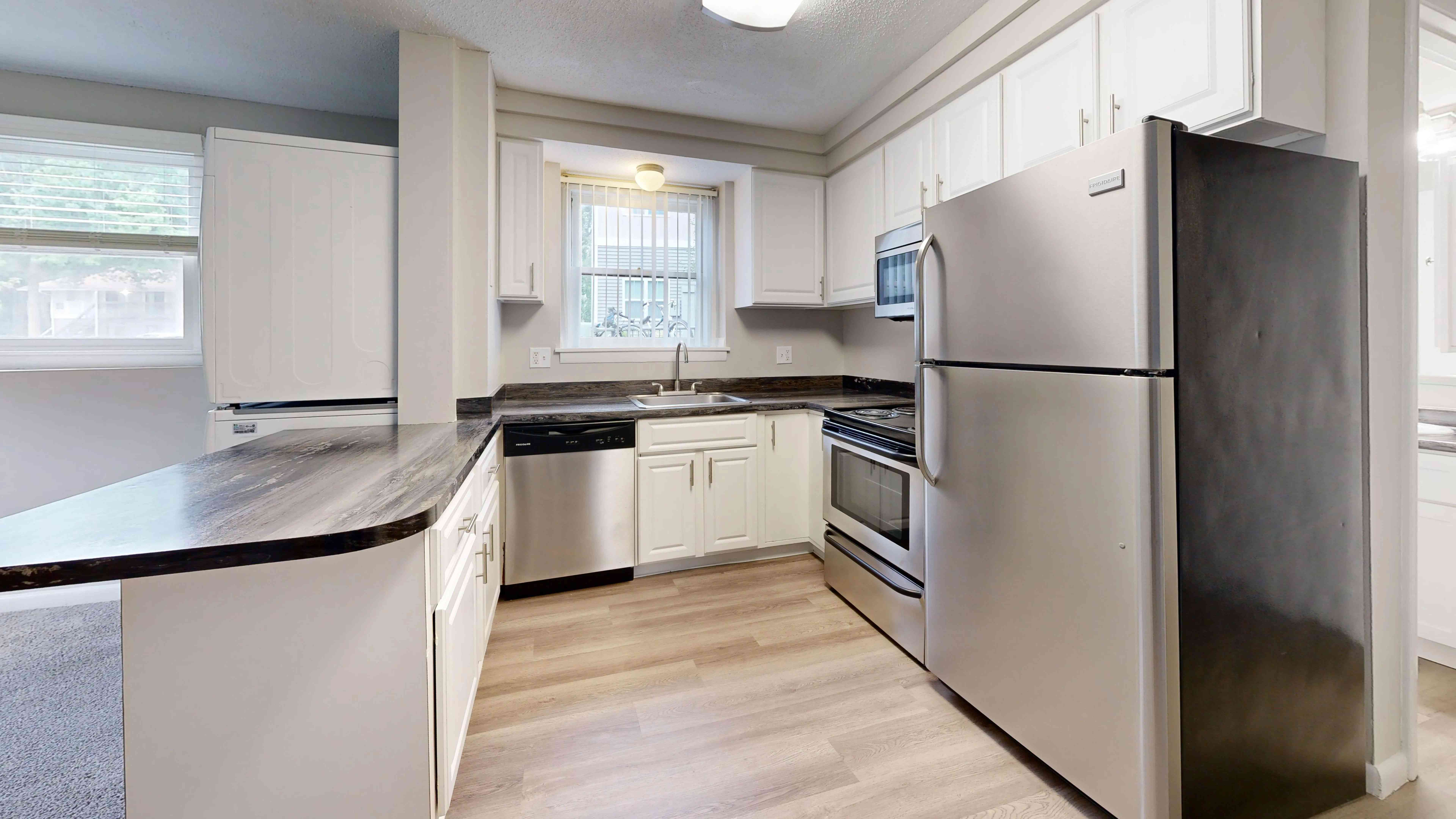 Experience the sleek and functional kitchen in The Valley floor plan featuring stainless steel appliances, ample cabinet space, and elegant countertops for a contemporary look.