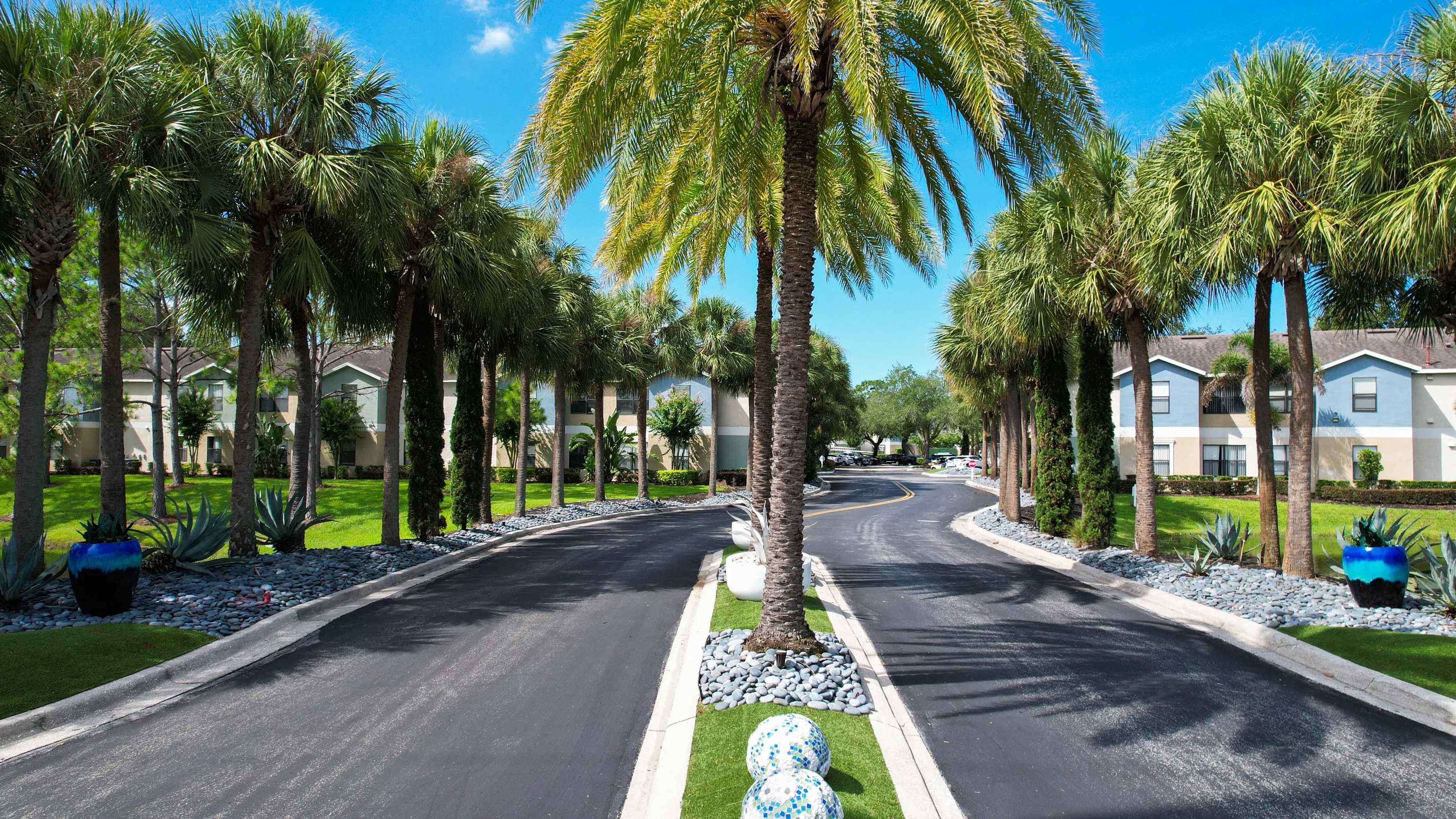 Welcome to Harper Grand Apartments! Our grand entrance, lined with majestic palm trees and vibrant landscaping, sets the stage for the luxurious living experience that awaits you. 