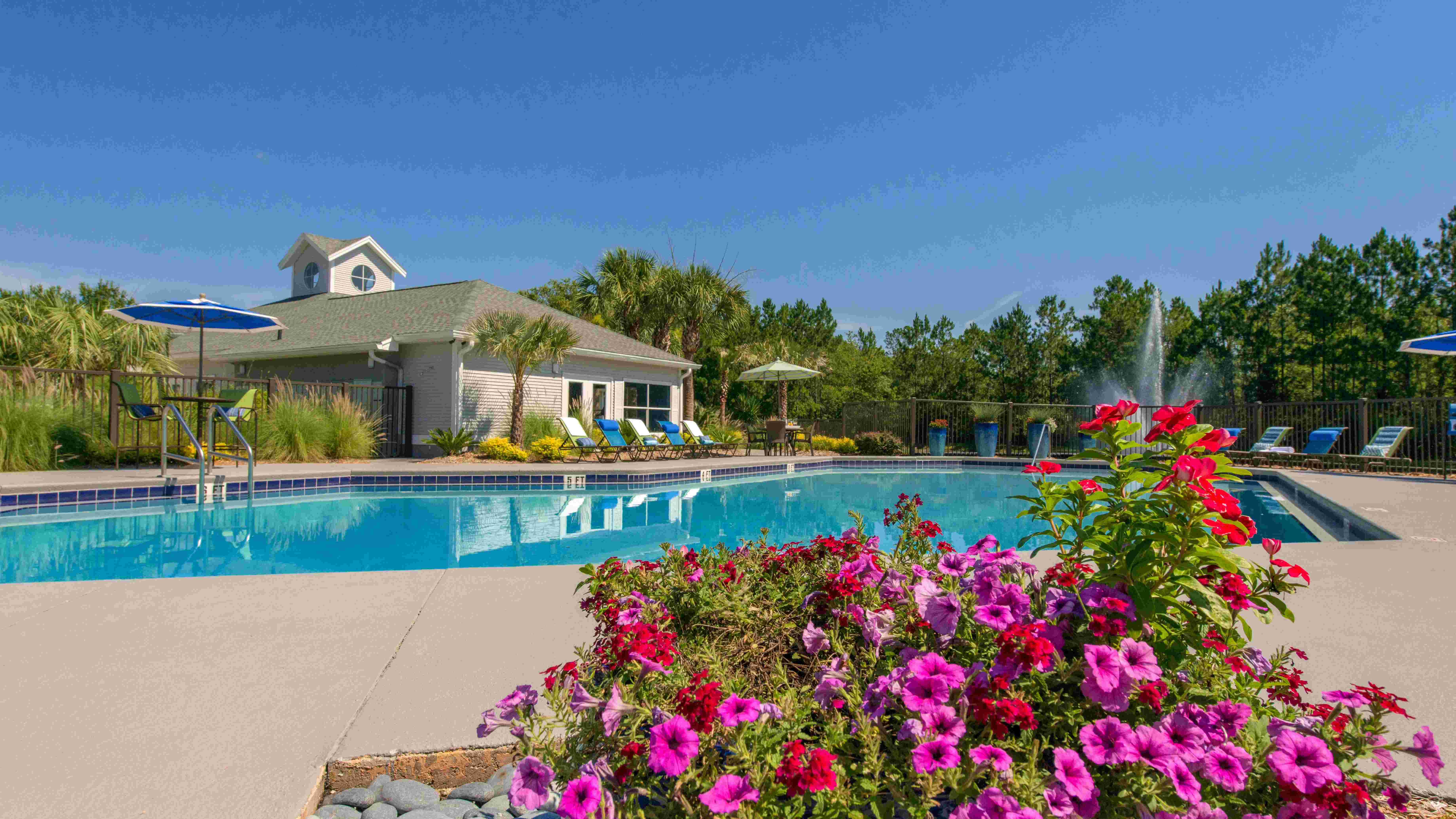 Relax and revel in the magic of our sun-drenched pool area. Lush landscaping frames this sun-soaked oasis.