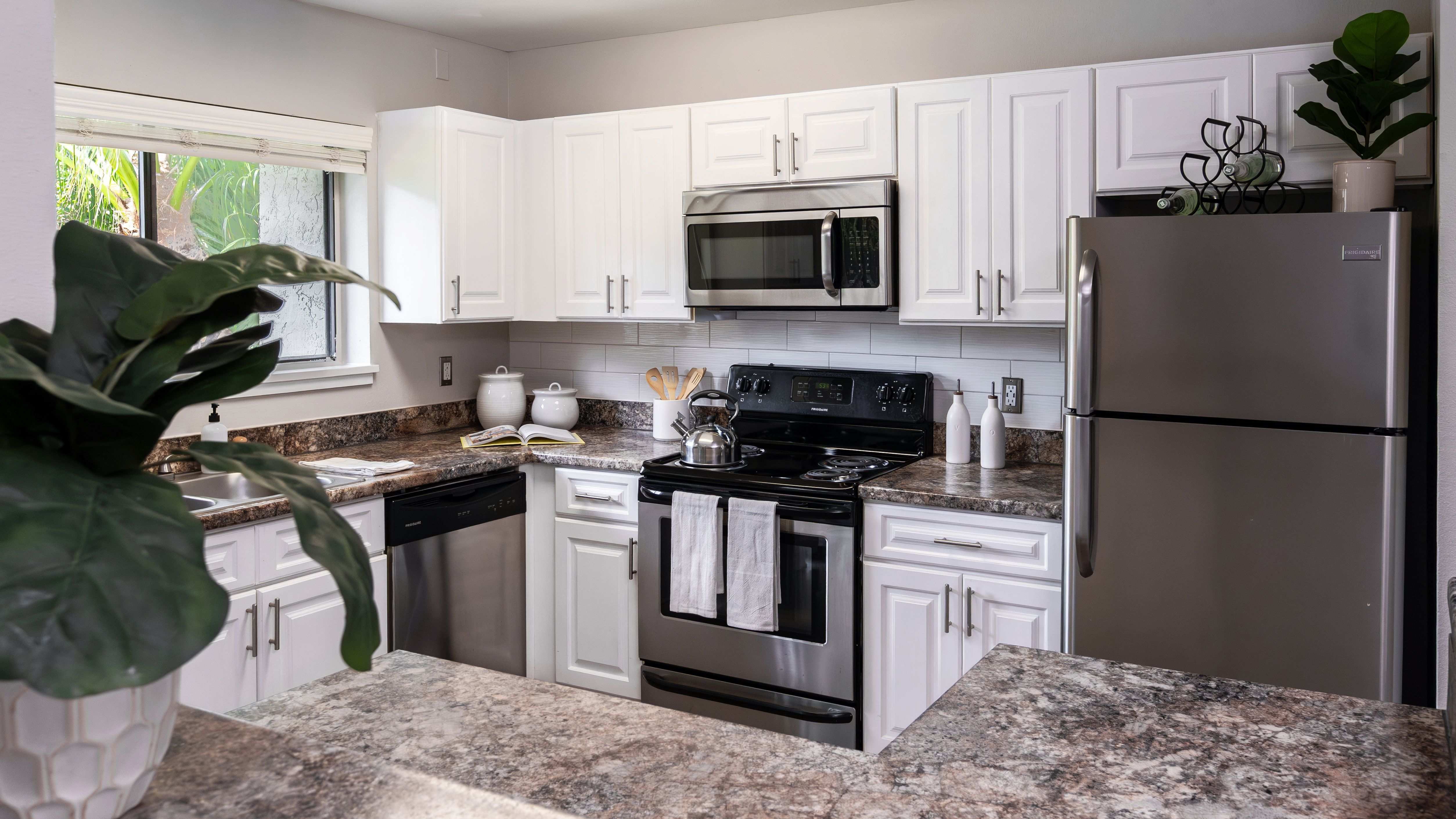 Cook in style with a fully equipped kitchen featuring stainless steel appliances, granite-style countertops, and ample cabinetry.