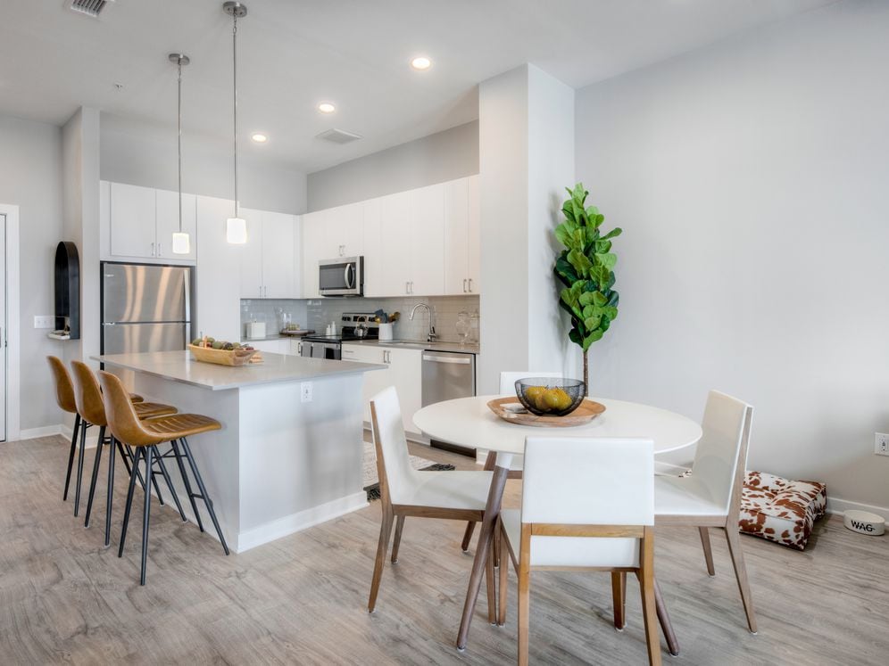 Scheme 1 kitchen with quartz countertops, tile backsplash, stainless steel appliances and hard surface flooring