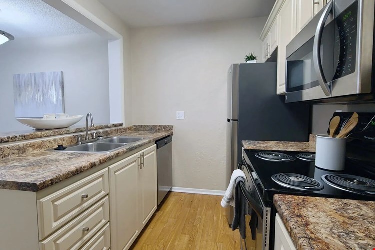 Kitchen love, where open-concept living begins with granite-style countertops and gleaming stainless allure.