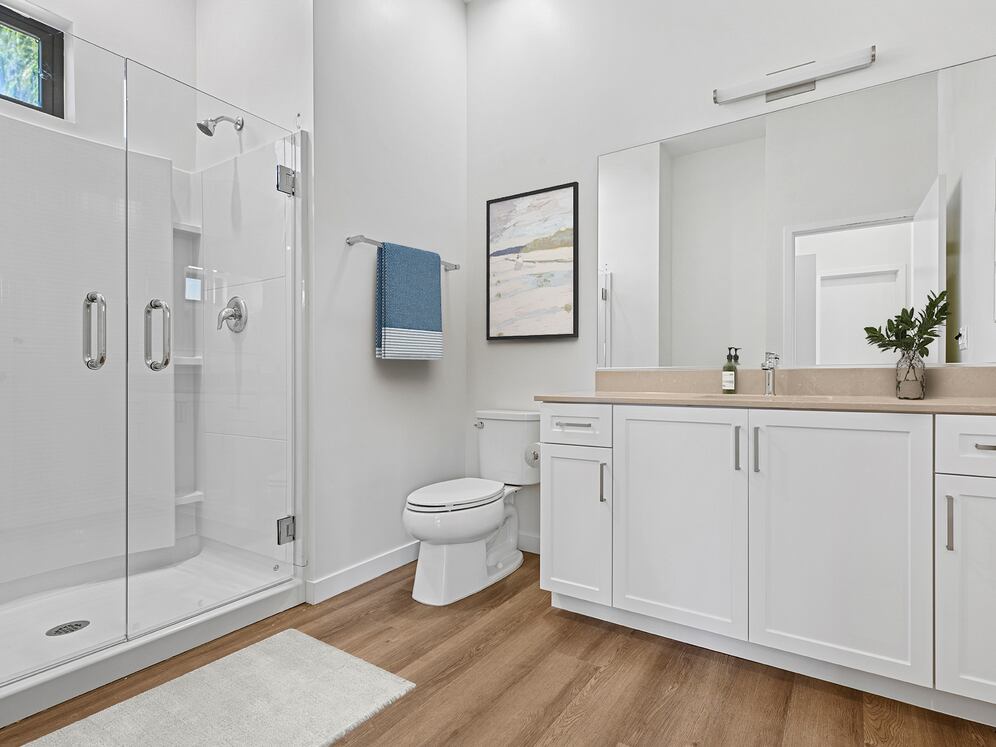 Coming Soon: Freestanding Home bath with beige quartz countertop, white cabinetry, and hard-surface flooring