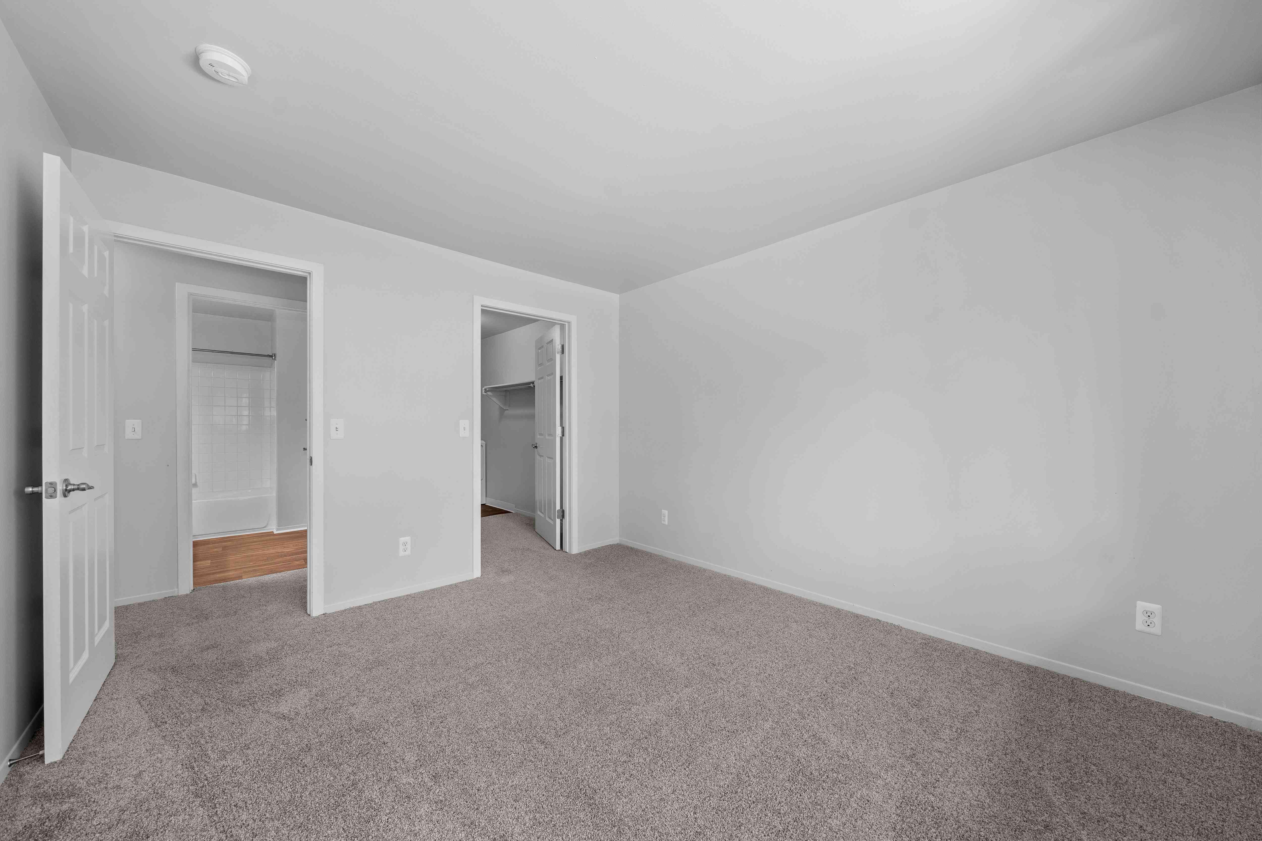 Spacious bedroom with ample storage space at Woodland Villa Apartments in Westland, MI.