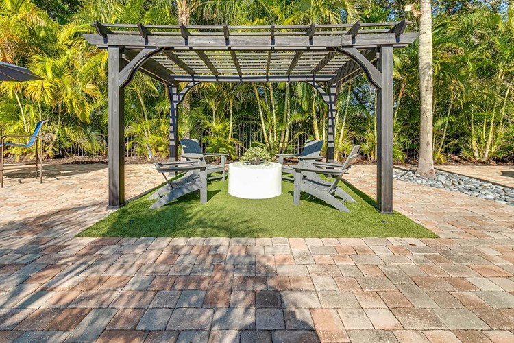 Relax under one of our poolside pergolas.