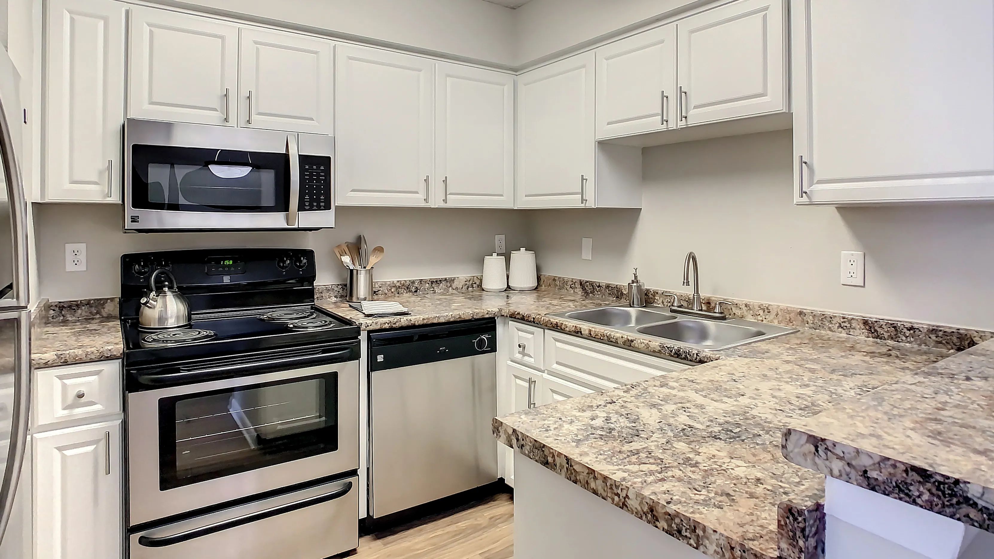 Immerse yourself in your dream kitchen with modern white cabinetry, granite-inspired countertops, and sleek stainless-steel appliances.